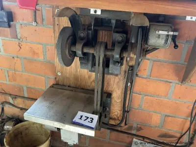 Wandgemonteerde slijpmachine met riemaandrijving, voorzien van een slijpschijf en een werkblad. Inclusief bedieningskast – kavel bij Appelboom