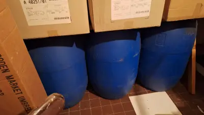Drie grote blauwe kunststof vaten geplaatst onder kartonnen dozen – kavel bij Goeiendeal, Houthalen-Helchteren
