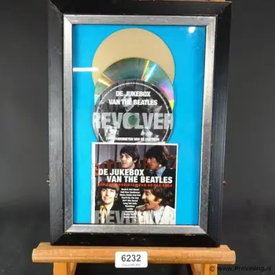 Ingelijste cd van The Beatles getiteld "De Jukebox van The Beatles" – kavel bij ProVeiling, Wageningen