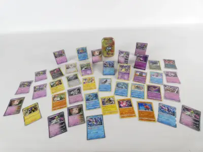 Lot van 40 Pokémon kaarten + Mini Tin (Frans/Engels/Japans) – kavel bij De Kringwinkel, Heverlee