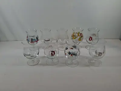 Set van 9 Duvel bierglazen met diverse opdrukken – kavel bij De Kringwinkel, Oudenaarde