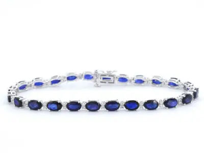 Witgouden tennisarmband met diamanten en saffier – kavel bij Onlineveilingmeester