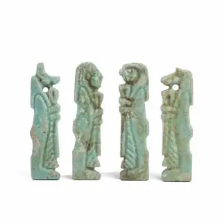 Egypt, a set of four blue faience amulets, the four son's of Horus, Ptolomaic Period – kavel bij Veilinggebouw De Zwaan, Amsterdam