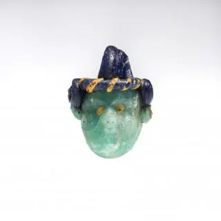A fine Phoenician light green glass paste face bead/mask, ca. 6th century BCE – kavel bij Veilinggebouw De Zwaan, Amsterdam